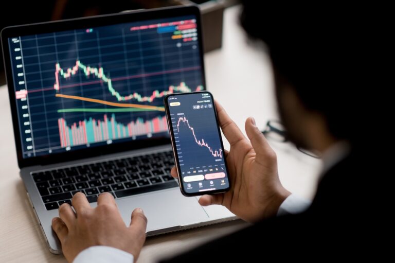Close-up,Of,Laptop,And,Smart,Phone,Screen,With,Diagrams.,Crypto,
