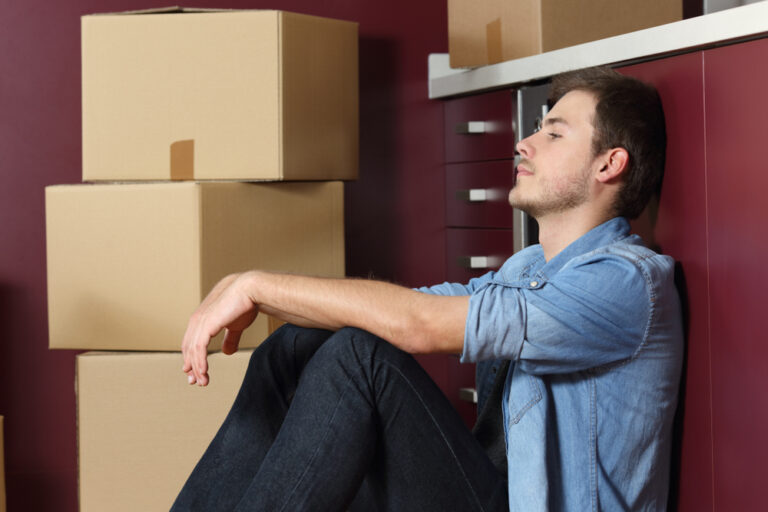 Side,View,Portrait,Of,A,Sad,Man,Moving,Home,Sitting