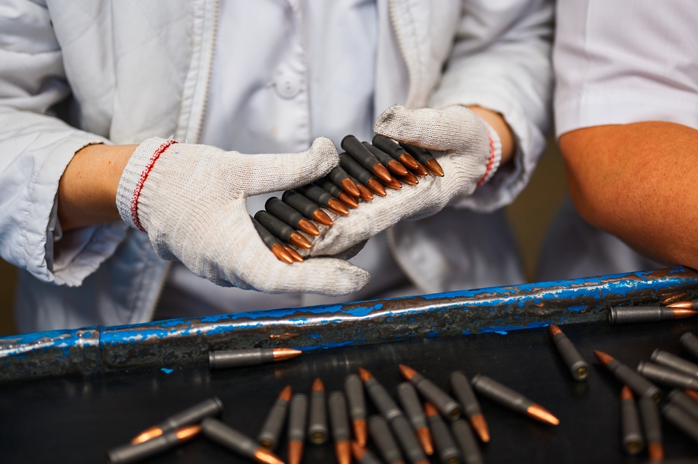 Employee,In,Gloves,Holds,Riffle,Cartridges,At,Workplace