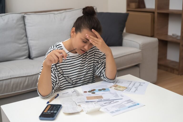 Woman,Carefully,Examines,Papers,With,Prices,Of,Utilities,For,Month