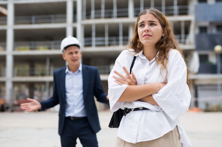 Disappointed,Woman,Standing,In,Construction,Plant.,Male,Engineer,In,Suit