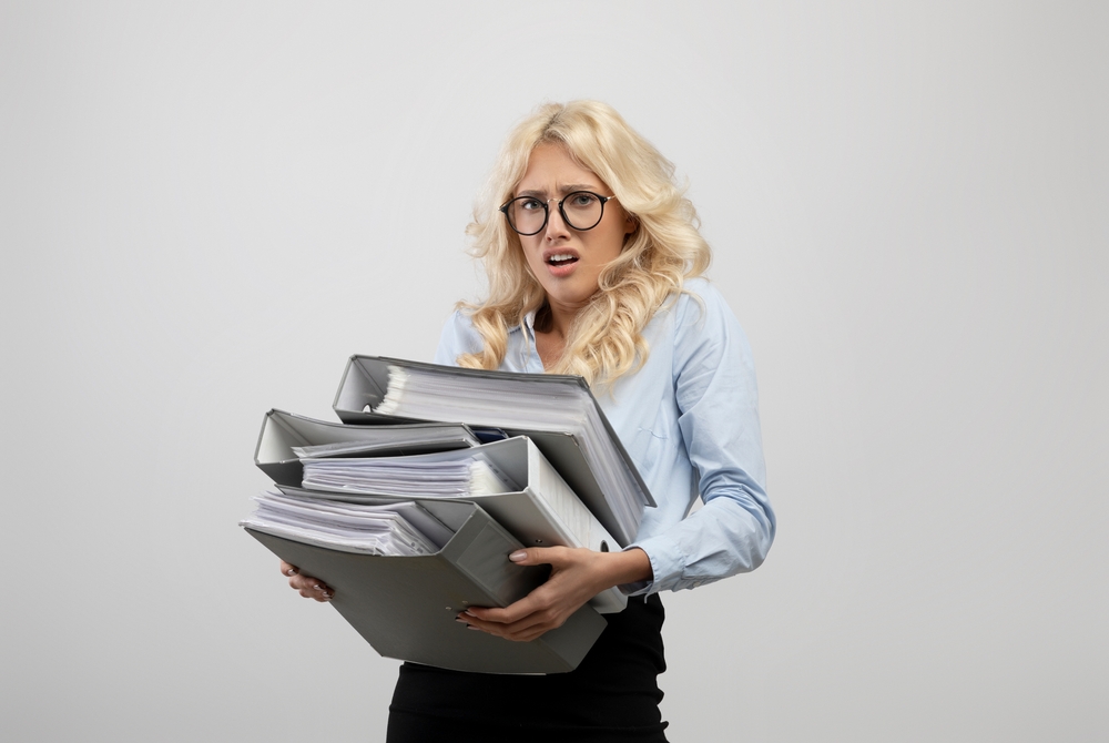 Stressed,Office,Worker,Overloaded,With,Papers,,Holding,Folders,Of,Documents,