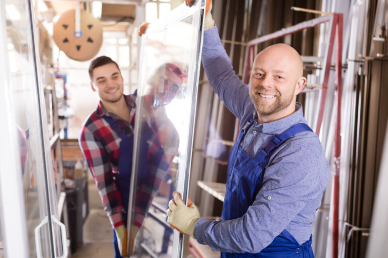 Portrait,Of,Two,Workers,In,Coverall,Working,With,Pvc,Window