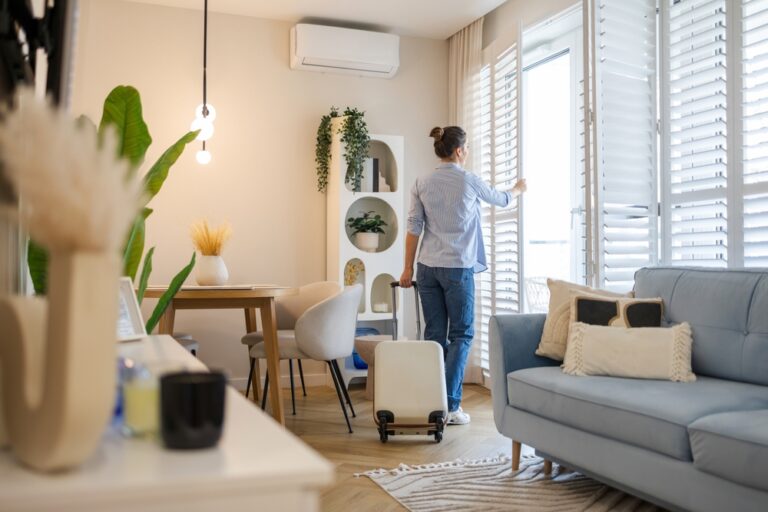 Young,Woman,With,Her,Suitcase,In,A,Rented,Apartment