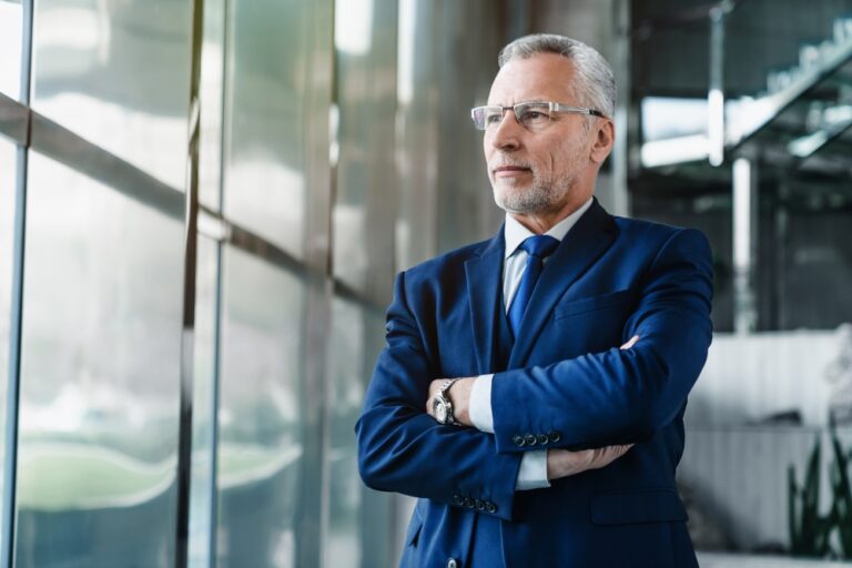 Side,View,Of,Senior,Businessman,Ceo,Standing,In,Office,Lobby