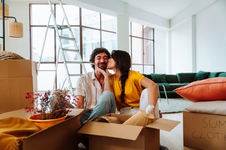 Happy,Young,Couple,Relocating,In,A,New,Apartment.,Young,Woman
