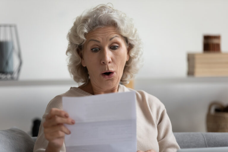 Head,Shot,Surprised,Middle,Aged,Mature,Woman,Looking,At,Paper
