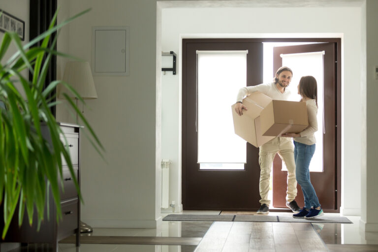 Happy,Young,Couple,Carrying,Cardboard,Boxes,Opening,Door,Entering,Inside