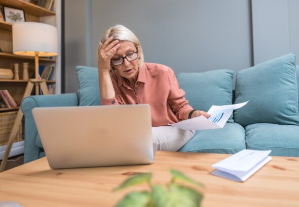 Senior,Woman,Shocked,By,Unexpectedly,High,Utility,Bill,While,Checking