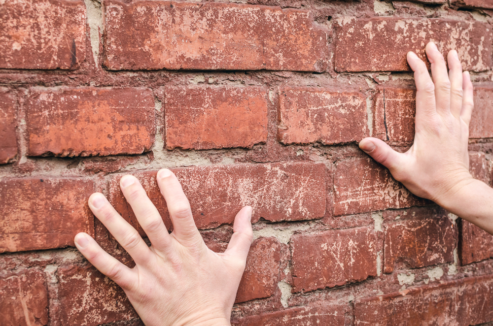 Male,Hands,Rested,Against,The,Brick,Wall,And,Tried,To