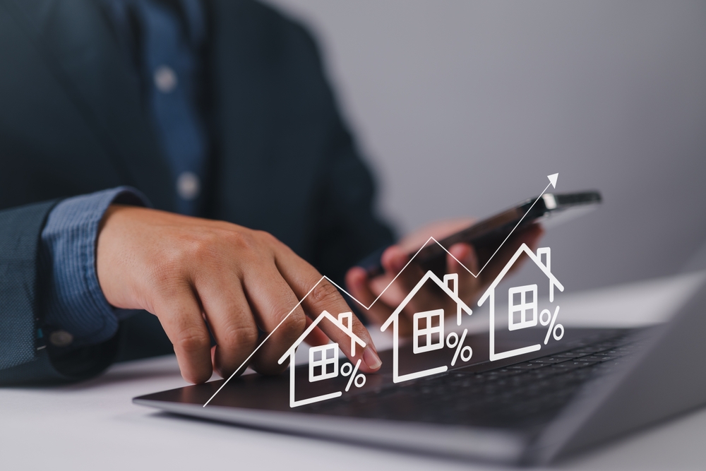 Real,Estate,Investment,Concept.,Person,Using,Laptop,With,House,Icon