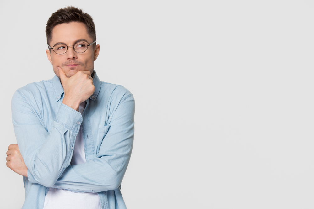 Thoughtful,Suspicious,Young,Man,Looking,Aside,At,Copy,Space,Feeling
