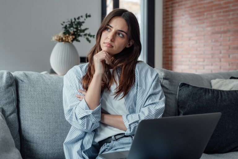 Distracted,From,Work,Worried,Young,Woman,Sitting,On,Couch,With