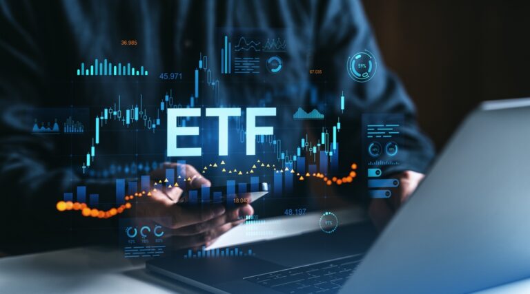 Person,Using,Smartphone,And,Laptop,With,Etf,Data,,Stock,Charts,