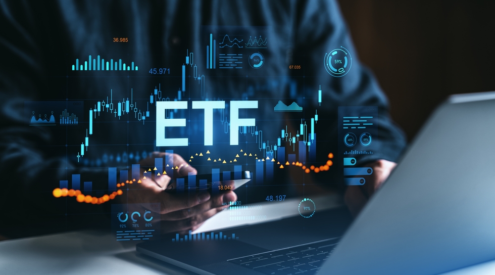 Person,Using,Smartphone,And,Laptop,With,Etf,Data,,Stock,Charts,