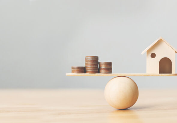 Wooden,Home,And,Money,Coins,Stack,On,Wood,Scale.,Property