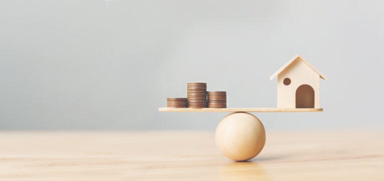 Wooden,Home,And,Money,Coins,Stack,On,Wood,Scale.,Property