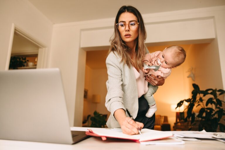 Design,Professional,Making,Notes,While,Holding,Her,Baby.,Multitasking,Mom