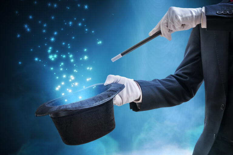 Magician,Or,Illusionist,Is,Showing,Magic,Trick.,Blue,Stage,Light