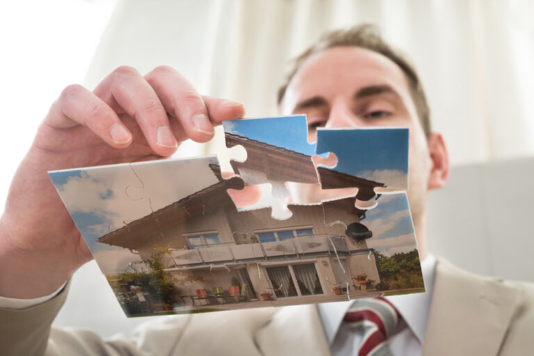 Close-up,Of,Businessman,Making,The,House,Of,Puzzle