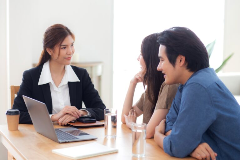 Happy,Asian,Couple,Discussion,With,Real,Estate,Agent,Or,Insurance