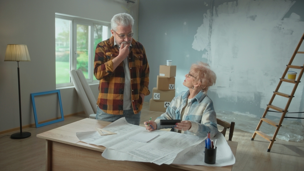 Elderly,Man,And,Woman,Are,Calculating,Expenses,Of,Repairing,An