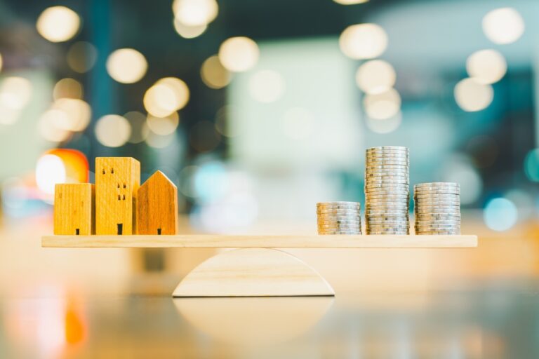 Wood,House,And,Coins,Stack,With,Balance,Scale.,Money,Management,