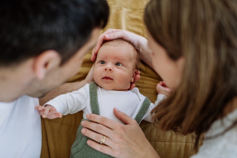 Happy,Parents,Cuddling,With,Their,Newborn,Baby.