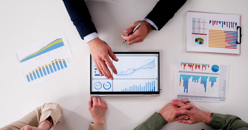 Financial,Planner,Helping,Couple,With,Tax,And,Investment,Advice,In