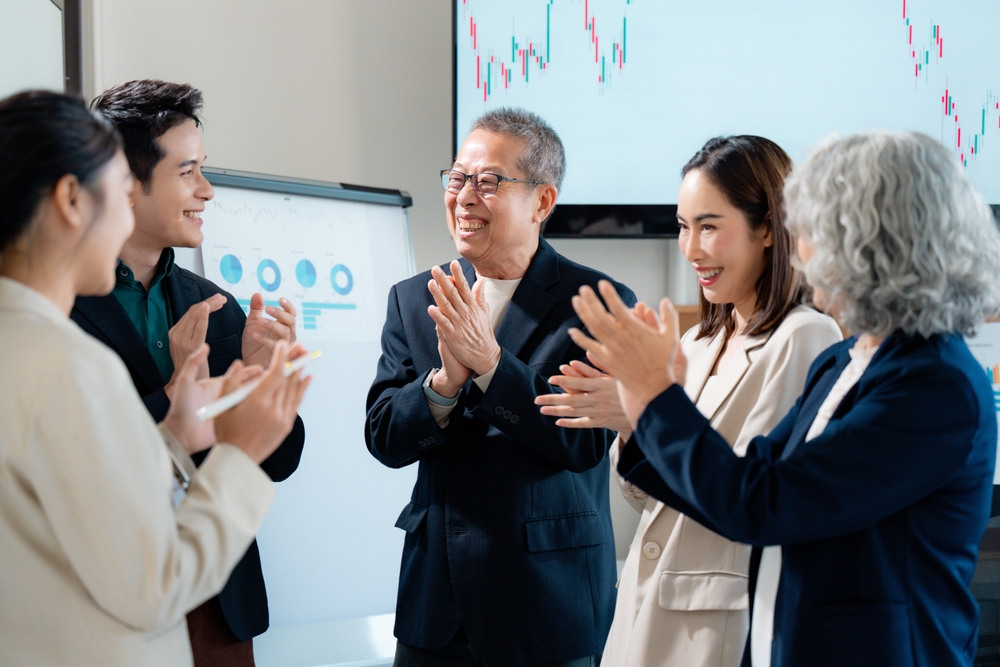 Colleagues,Applauding,,Sharing,Excitement,After,Achieving,Corporate,Milestone,In,Workplace