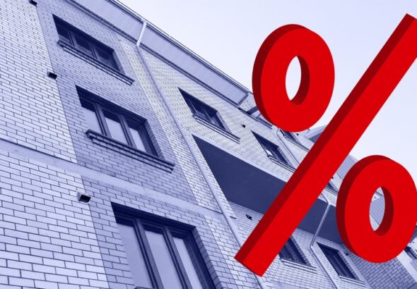 Large,Red,3d,Percentage,Sign,On,New,Multi-story,Residential,Building