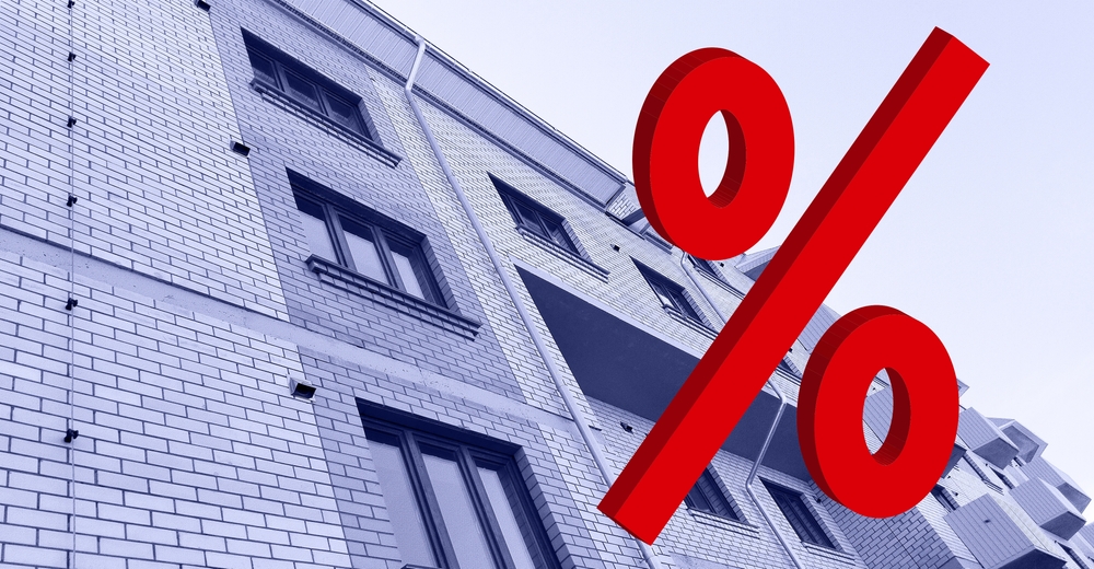 Large,Red,3d,Percentage,Sign,On,New,Multi-story,Residential,Building