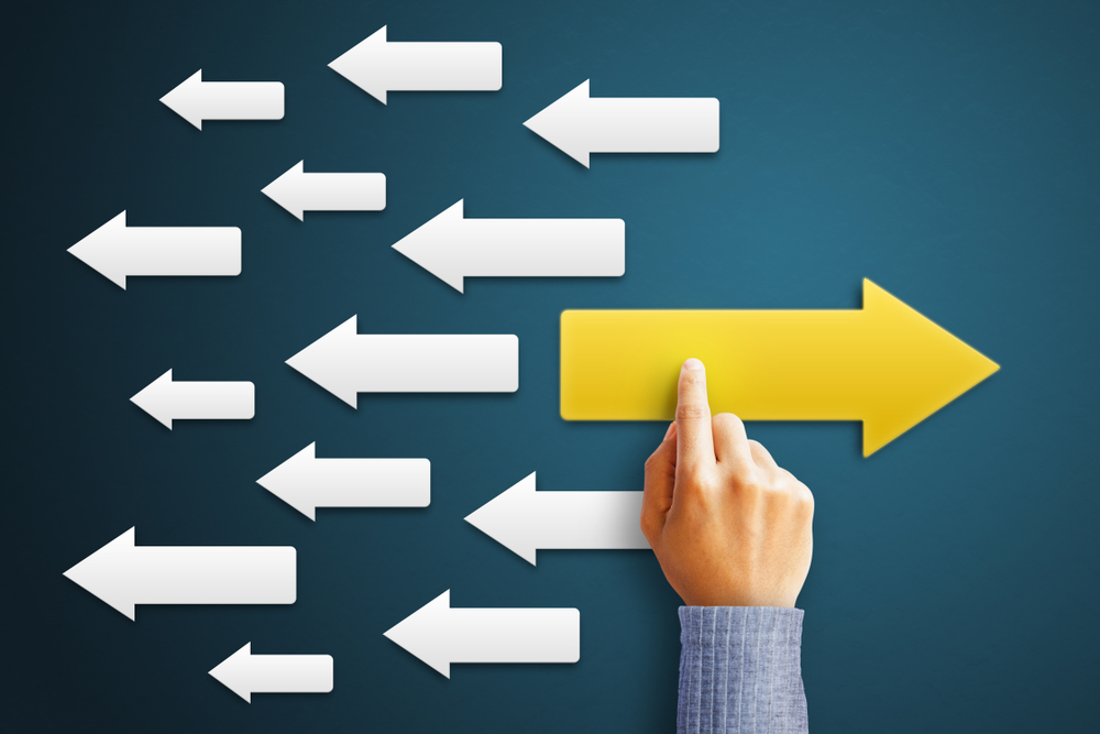 Businessman,Is,Touching,Arrow,Pointing,Opposite,With,Arrows,White,As