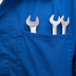 Mechanic with wrenches in pocket