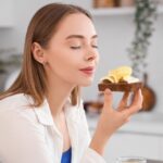 Beautiful,Young,Happy,Woman,Holding,Tasty,Toast,With,Fresh,Butter