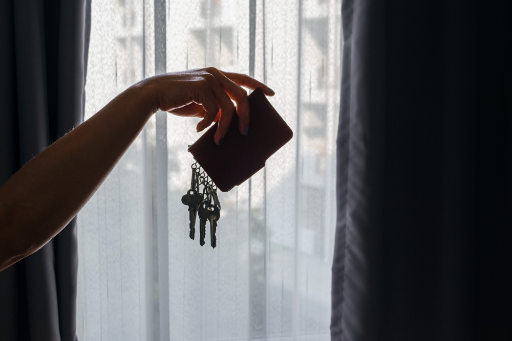 Asian,Female,Hand,Holding,Leather,Key,Holder,With,Backlight,And
