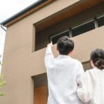 Couple,And,Family,Pointing,At,Their,Newly,Built,Home,(mortgage