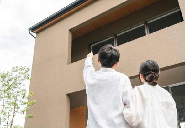 Couple,And,Family,Pointing,At,Their,Newly,Built,Home,(mortgage