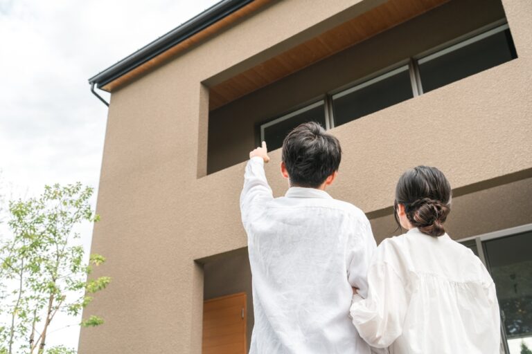 Couple,And,Family,Pointing,At,Their,Newly,Built,Home,(mortgage