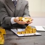 Illustration,Of,Businessman,Working,Hard,With,Gold,Bars,,Evaluating,Investments