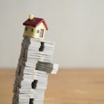 Model,House,On,Us,Dollar,Banknotes,With,White,Wall,Background