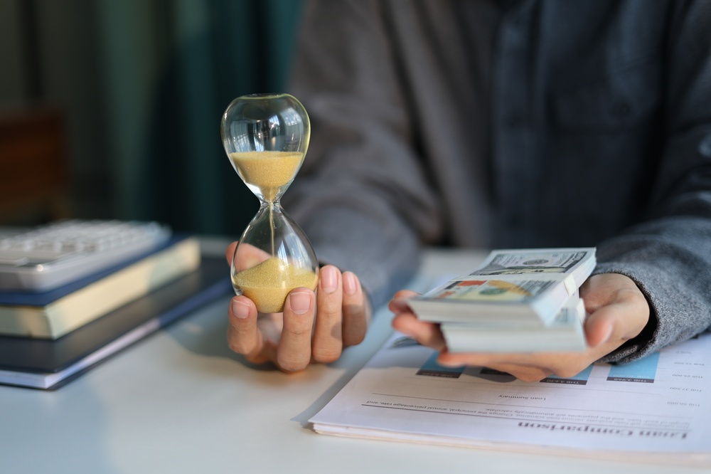Time,And,Money,Concept.,Businessman,Holding,Cash,And,Sand,Clock