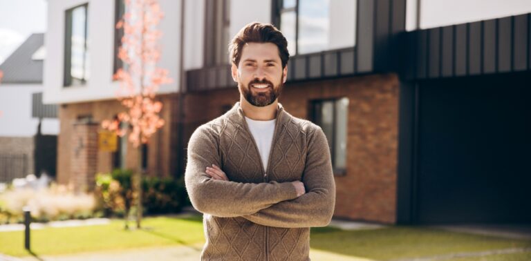 Smiling,Confident,Man,Homeowner,Standing,With,Crossed,Arms,In,Front
