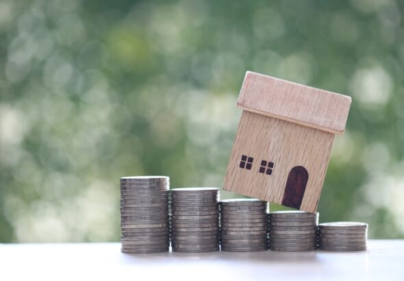 Mortgage,model,House,And,Stack,Of,Coins,Money,On,Natural,Green