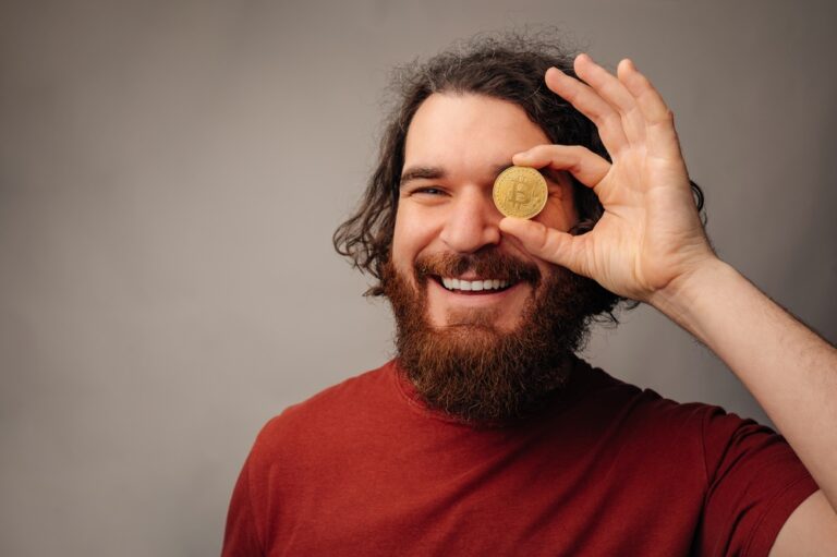 Jovial,Male,Investor,Displaying,Bitcoin,Coin,With,Joyful,Expression,And
