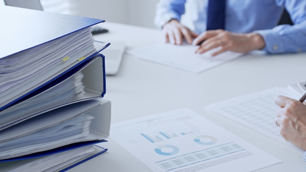 Team,Of,Accountants,Or,Auditors,Are,Analyzing,Financial,Reports,And