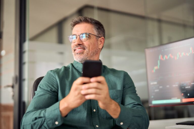 Crypto,Investor,Broker,Using,Smartphone,Trading,App,On,Cell,Phone.