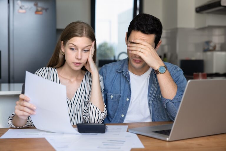 Concerned,Young,Couple,Of,Tenants,,Renters,Checking,Too,High,Paper