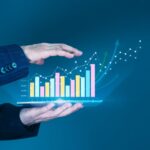 Businessman',Hand,Supports,A,Rising,Graph,On,A,Tablet,,Representing