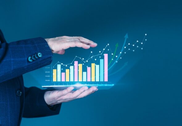 Businessman',Hand,Supports,A,Rising,Graph,On,A,Tablet,,Representing